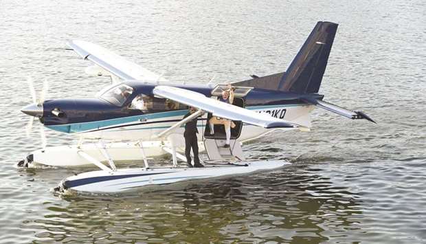 Prime Minister Narendra Modi waves as he stands on a seaplane after landing at the Sabarmati river in Ahmedabad yesterday.