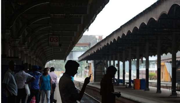 Passengers wait for trains at the Fort railway station during a nationwide railway strike in Colombo yesterday.