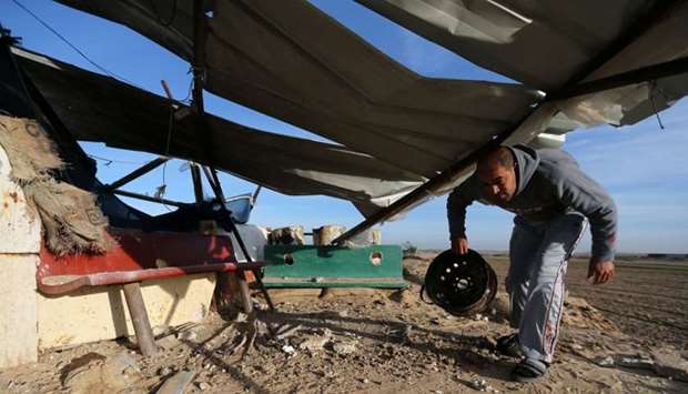 A Palestinian man inspects a militant target that was hit in an Israeli airstrike in the southern Gaza Strip