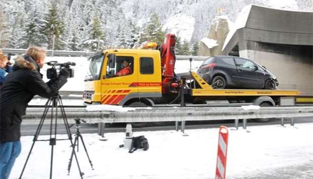 A truck removes a car after an accident in the Gotthard tunnel in Goeschenen, Switzerland, on Wednesday.