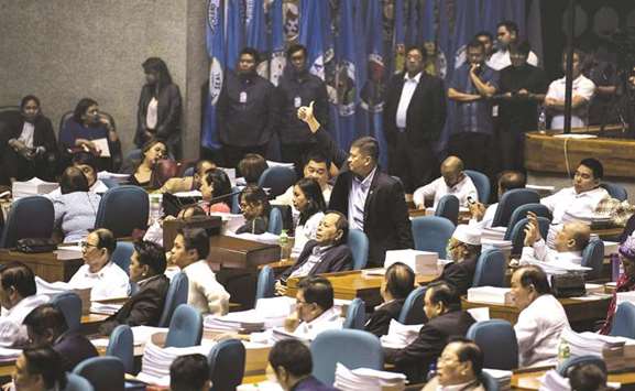 A congressman gives a thumbs up as he votes for the extension of Martial Law in Mindanao at the session hall of the House of Representatives in Manila yesterday.