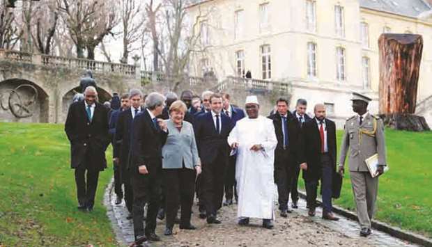From left: Italian Prime Minister Paolo Gentiloni, German Chancellor Angela Merkel, Franceu2019s President Emmanuel Macron and Maliu2019s President Ibrahim Boubacar Keita arrive for a press conference at La Celle-Saint-Cloud, near Paris, during a summit from the underfunded G5 Sahel anti-terror coalition, yesterday.