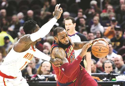 Cleveland Cavaliers forward LeBron James (right) drives against Atlanta Hawks guard Dennis Schroder in the first quarter at Quicken Loans Arena. PICTURE: USA TODAY Sports
