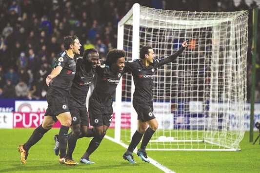 Chelseau2019s Spanish midfielder Pedro (right) celebrates with teammates after scoring their third goal during the English Premier League match against Huddersfield Town in Huddersfield, northern England. (AFP)