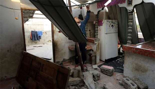 A Palestinian man inspects a house damaged in an Israeli airstrike in the southern Gaza Strip on Wednesday.