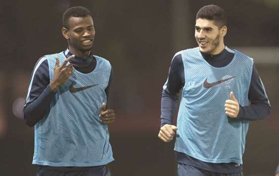 Qatar football players Mohamed Muntari and Karim Boudiaf jog during a training session in Doha yesterday. Qatar will take on Liechtenstein in a friendly international today in preparation for the Gulf Cup in Kuwait later this month.