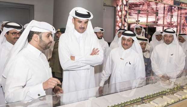 His Highness the Emir Sheikh Tamim bin Hamad al-Thani is briefed on a project at the 'Made in Qatar' exhibition on Thursday.