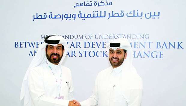 Al-Mansoori and al-Khalifa shake hands after signing the deal to support SMEs.rn