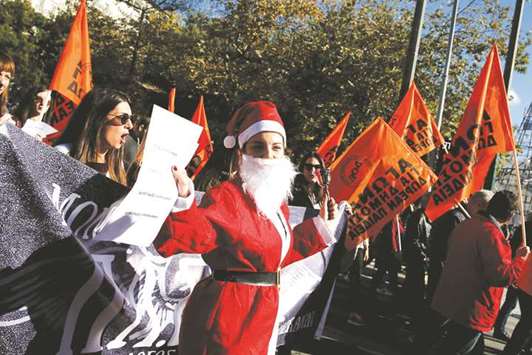 HO-HO-OH NO! A woman in a Santa Claus is seen as she takes part in a demonstration marking a 24-hour general strike against austerity in Athens.