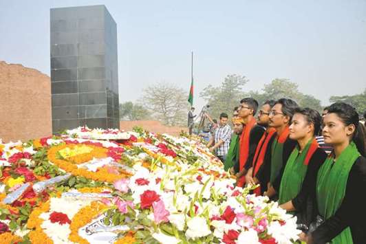 Bangladeshis pay tribute at the Martyred Intellectuals Memorial in Dhaka, Bangladesh, yesterday.