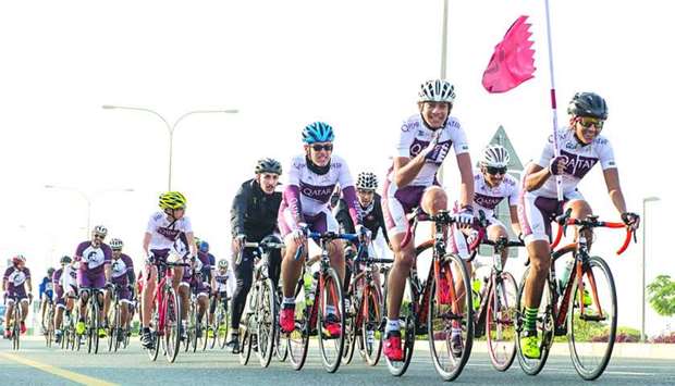 Qatar's National Cycling Team carry flag on first leg from Sealine Beach to Al Wakrahrn