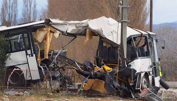 The wreckage of a school bus is pictured in Millas, near Perpignan, southern France, on Friday, a day after an accident when a train crashed into the school bus at a level crossing.