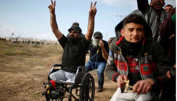 Wheelchair-bound Palestinian demonstrator Ibraheem Abu Thuraya, who according to medics was killed later on Friday during clashes with Israeli troops, gestures during a protest against U.S. President Donald Trump's decision to recognize Jerusalem as the capital of Israel, near the border with Israel in the east of Gaza City.