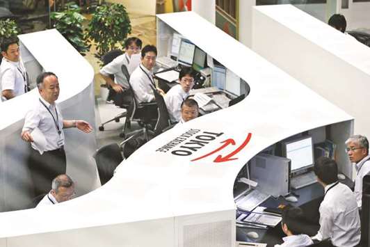 Employees work at the Tokyo Stock Exchange. The Nikkei 225 closed down 0.6% to 22,553.22 points yesterday.
