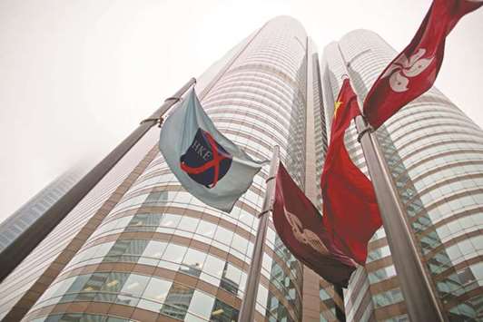 The flag of the Hong Kong Exchanges and Clearing (left) flies from a mast outside the stock exchange buildings in China. Hong Kong is set to allow controversial dual-class shares under rule changes to be proposed by the cityu2019s stock exchange as it raises the stakes in its battle against New York for blockbuster Chinese initial public offerings.