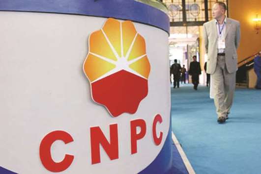 A Chinese visitor walks past the stand of China National Petroleum Corporation (CNPC), parent company of PetroChina, at an exhibition in Beijing (file). Chinau2019s top oil and gas company is considering taking over Totalu2019s stake in a giant Iranian gas project if the French company leaves Iran to comply with any new US sanctions, industry sources said.