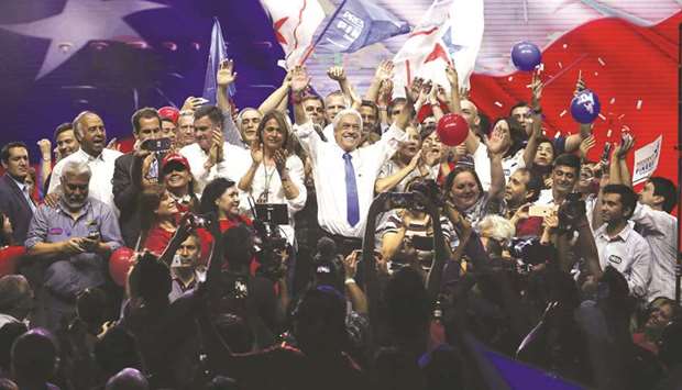 Chilean presidential candidate Sebastian Pinera waves to the crowd, surrounded by his family and supporters, during his final election campaign rally in Santiago.