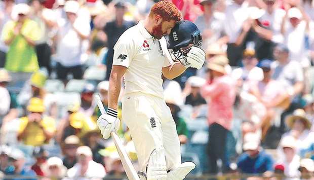 Englandu2019s Jonny Bairstow taps his helmet with his head after reaching his century against Australia yesterday.