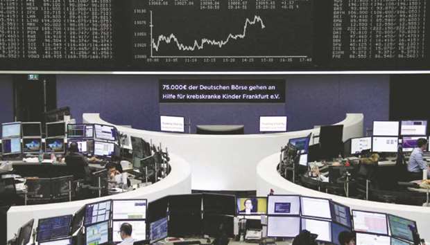 Traders work at the Frankfurt Stock Exchange. The DAX 30 closed up 0.3% to 13,103.56 points yesterday.