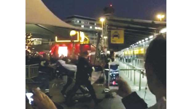 Paramedics are seen with the suspect on stretchers at  Amsterdamu2019s Schiphol Airport in this still image obtained from social media video.