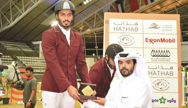 Saeed Nasser al-Qadi receives his prize after winning the Open Class event yesterday.