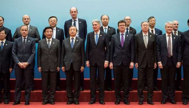 Britain's Chancellor of the Exchequer Philip Hammond and Chinese Vice Premier Ma Kai pose with delegates during the UK-China Economic Financial Dialogue at the Diaoyutai State Guesthouse in Beijing