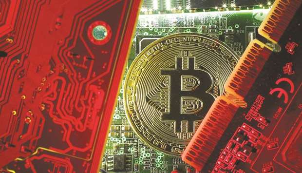 A coin representing the bitcoin cryptocurrency is seen on computer circuit boards in this illustration picture. Complacency test in 2018 might come from a shock u2013 especially a collapsing asset bubble.