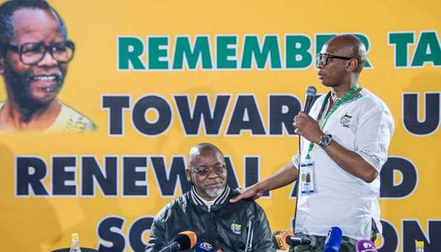 South Africa's ruling African National Congress (ANC) spokesperson Zizi Kodwa (R) gives a speech next to ANC Secretary General, Gwede Mantashe, during the national executive committee (NEC) meeting