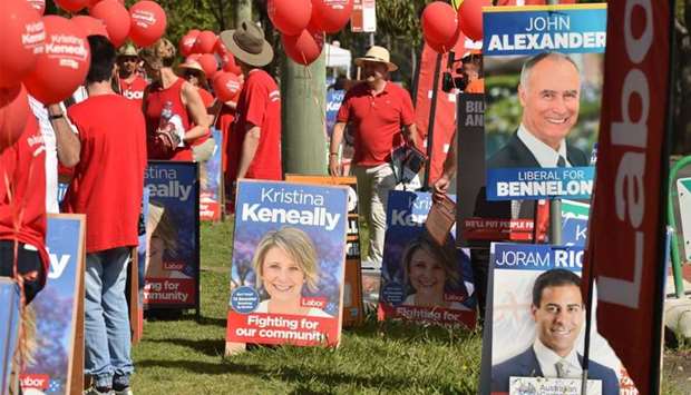 Banners and placards are seen displayed outside a polling station in the suburban seat of Bennelong in Sydney