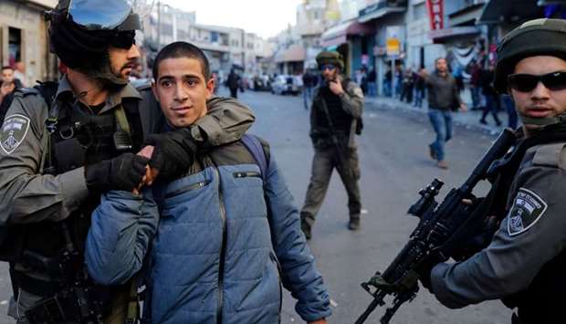 A Palestinian man is detained by Israeli security forces in Jerusalem on December 16, 2017, as demonstrations continue to flare in the Middle East and elsewhere over the US president's declaration of Jerusalem as Israel's capital.