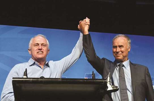 Prime Minister Malcolm Turnbull and newly-elected Liberal member for Bennelong John Alexander celebrate at the by-election night party at the West Ryde Leagues Club in Sydney, yesterday.
