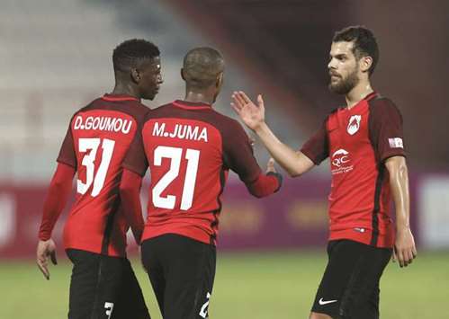 Al Rayyanu2019s Daniel Goumou (left) celebrates with his teammates after scoring a goal against Al Kharaitiyat during their QSL Cup semi-final yesterday.