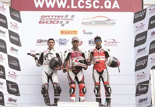 Saeed al-Sulaiti (centre) poses on the podium after winning the opening round of the Qatar Superstock 600 Championship yesterday.