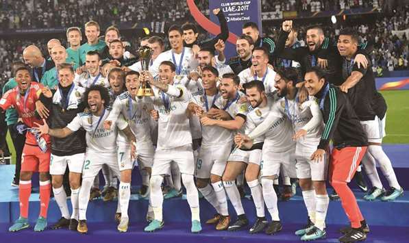 Real Madrid players celebrate with the FIFA Club World Cup trophy after their victory in the final against Gremio yesterday. (AFP)