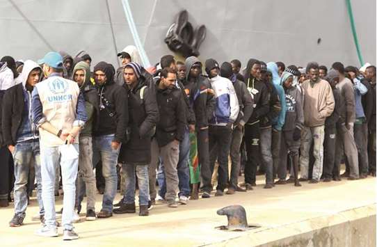 Illegal immigrants arrive at a naval base in Tripoli yesterday, after they were rescued off the coast of Garabulli, 60 kilometres east of the Libyan capital.