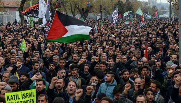 Pro-Palestinian protesters wave flags during a demonstration against the US president's decision to recognise Jerusalem as the capital of Israel in Diyarbakir.