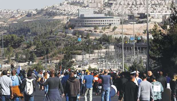 Israeli employees of Teva, the worldu2019s biggest manufacturer of generic drugs, walk towards the pharmaceutical giantu2019s plant in Jerusalem yesterday during a demonstration against plans by the group to shed employees. Teva is said to make 1,750 employees redundant in Israel as part of plans to slash 14,000 jobs globally over two years.