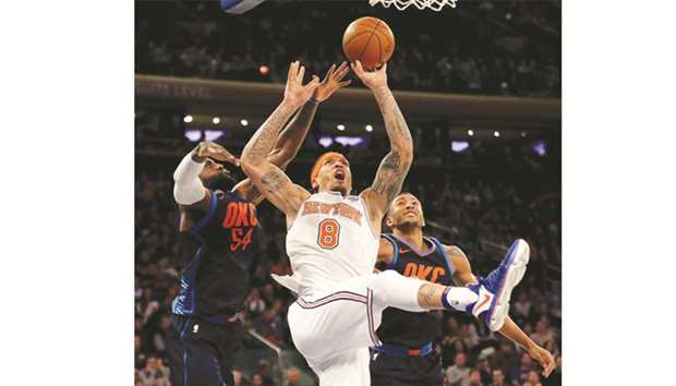 Michael Beasley of the New York Knicks takes a shot against  Patrick Patterson and Josh Huestis of the Oklahoma City Thunder in the third quarter during their game at Madison Square Garden on Saturday.