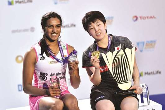 Japanu2019s Akane Yamaguchi (right) celebrates after winning the final against Indiau2019s PV Sindhu at the BWF World Superseries Finals in Dubai yesterday. (AFP)