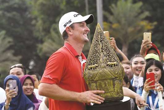 Justin Rose of England celebrates with the trophy after winning the Indonesian Masters golf tournament in Jakarta, Indonesia, yesterday. (AFP)