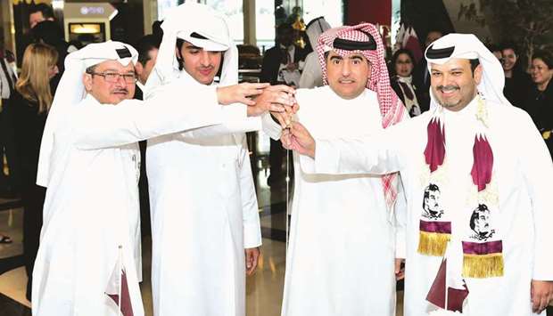 Hamad Abdulla al-Mulla (second, right) leads the cake-cutting ceremony to celebrate National Day.