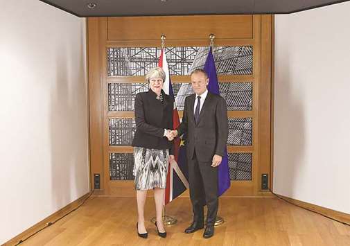 Prime Minister Theresa May shakes hands with European Union President Donald Tusk as she attends Brexit negotiationsu2019 meetings at the European Commission in Brussels.