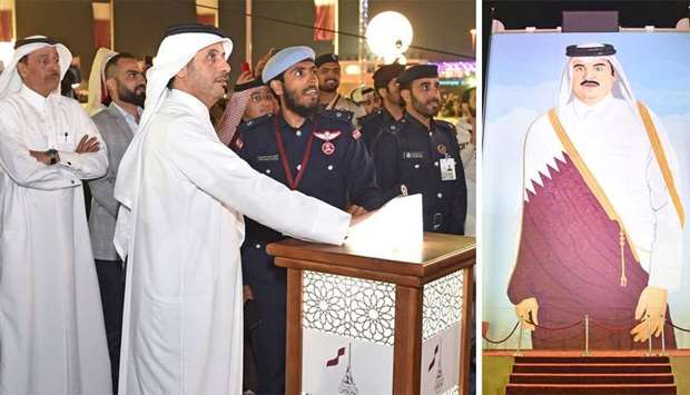 The portrait of His Highness the Emir Sheikh Tamim bin Hamad al-Thani (R) is being unveiled by HE the Prime Minister and Interior Minister Sheikh Abdullah bin Nasser bin Khalifa al-Thani in the Police College pavilion at Darb Al Saai. Pictures courtesy of MoI