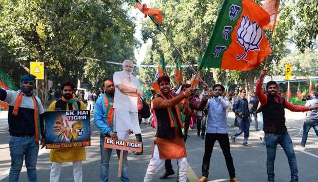Supporters of India's ruling Bharatiya Janata Party (BJP) celebrate outside the party headquarters
