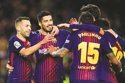 Barcelonau2019s Brazilian midfielder Paulinho (second right) celebrates with Barcelonau2019s Uruguayan forward Luis Suarez, Barcelonau2019s Spanish defender Jordi Alba and other teammates after scoring during the La Liga match against RC Deportivo de la Coruna at the Camp Nou stadium in Barcelona on Sunday. (AFP)