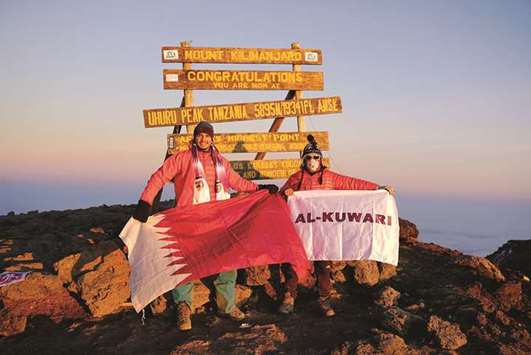 ON TOP OF THE WORLD: Margarita Zuniga and Omar al-Khanji at the Summit of Mt Kilimanjaro, where Margarita is holding the flag for her daughter-in-law. Photos: Flagler Films