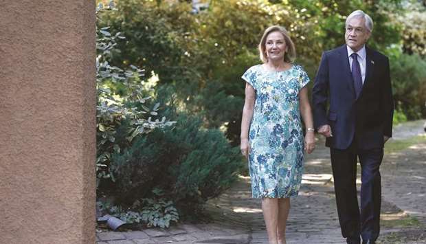Chilean president-elect Sebastian Pinera walks with his wife Cecilia Morel to a press conference in Santiago.