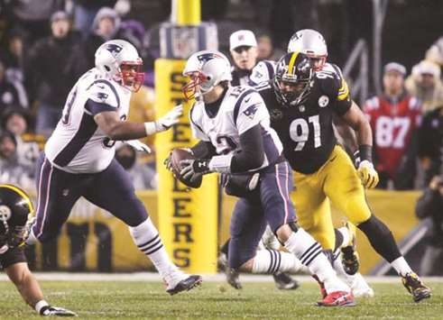 New England Patriots quarterback Tom Brady (centre) scrambles away from Pittsburgh Steelers defensive end Stephon Tuitt (right) during the first quarter of their game in Pittsburgh, Pensylvania, on Sunday. (USA TODAY Sports)