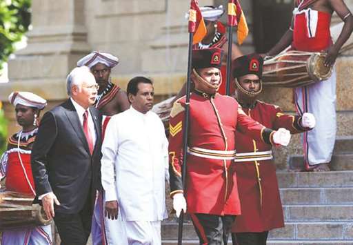 Malaysian Prime Minister Datuk Seri Najib Tun Razak, left, and Sri Lankan President Maithripala Sirisena attend a welcoming ceremony at the Presidential Secretariat in Colombo yesterday.
