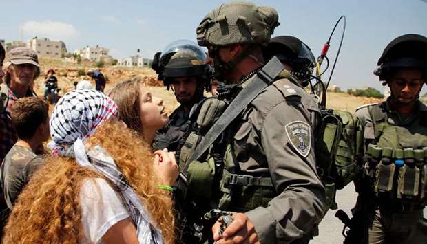 File photo shows 17-year-old Ahed Tamimi (centre) protesting before Israeli forces in the West Bank village of Nabi Saleh, north of Ramallah, on May 12, 2017.